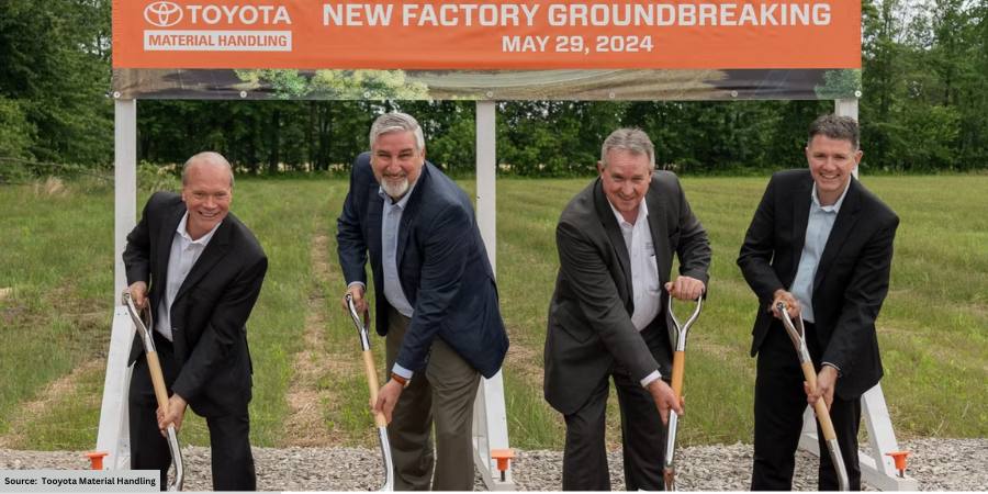 groundbreaking ceremony for Toyota Material Handling, banner in background, 4 men with shovels in the fg