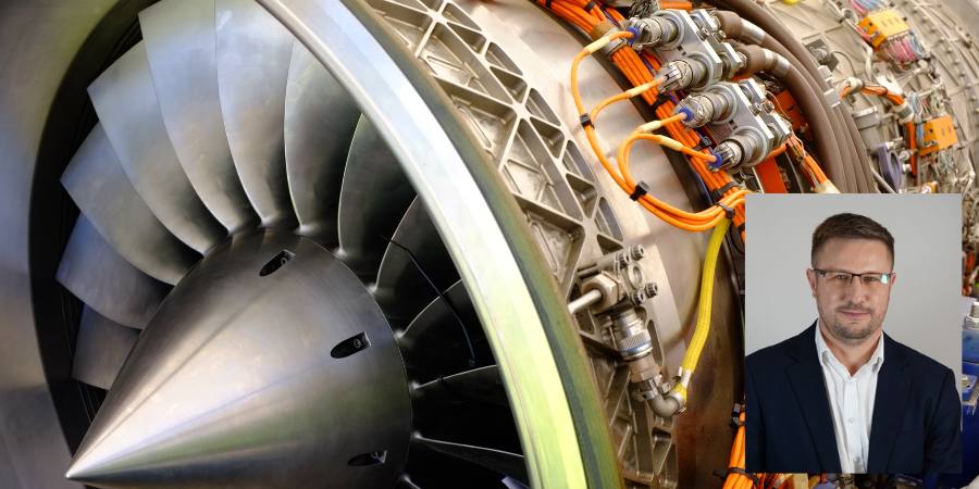 jet engine exposed parts in bg; inset of man, glasses, beard, suit jacket